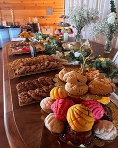 a table topped with lots of different types of pastries and desserts on top of it