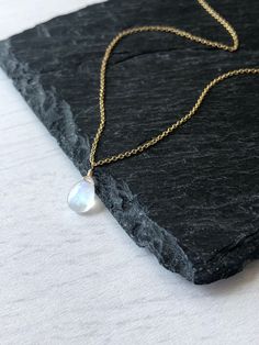 "Rainbow Moonstone Necklace, Smooth Rainbow Moonstone Teardrop Pendant, June Birthstone, Layering Summer Necklace, Minimalist Jewelry gift This simple and classic necklace features a smooth blue fire rainbow moonstone tiny teardrop suspended from a dainty chain in your choice of gold filled or sterling silver. This is the perfect summer necklace and is a classic effortless look for all ages. Important Note: Moonstone is a white color stone that shows the blue and green fire \"at an angle\", so i Dainty Moonstone Teardrop Pendant Necklace, Minimalist Moonstone Round Necklace, Blue Moonstone Teardrop Necklace, Moonstone Teardrop Necklace, Fire Rainbow, Black Moonstone, Rainbow Moonstone Necklace, Gold Necklace Simple, Classic Necklace