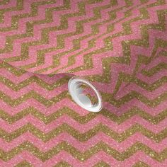 a pink and gold chevroned fabric with white thread on it's end