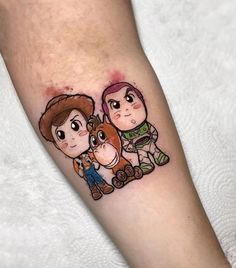 a cartoon tattoo on the leg of a person with a horse and two people behind it