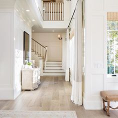 an image of a house with white walls and wood flooring on the phone screen