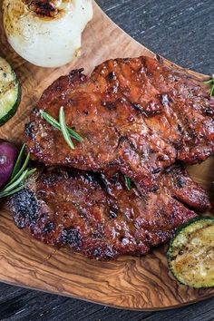 grilled meat and vegetables on a wooden platter