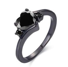 a black diamond ring with three stones on the front and side, set in 18k white gold