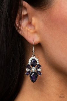 Featuring regal marquise, teardrop, and oval cuts, a sparkly collection of stunning purple rhinestones adorn a glittery backdrop of glassy white rhinestones, creating a dramatically dazzling centerpiece. Earring attaches to a standard fishhook fitting. Sold as one pair of earrings. Glittery Backdrop, Live Text, Bling Earrings, Purple Earrings, Purple Rhinestone, Paparazzi Accessories, White Rhinestone, Paparazzi Jewelry, Rhinestone Earrings