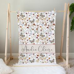 the personalized blanket is on display in front of a white background with flowers and butterflies