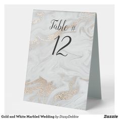 a table number card with gold and white marble