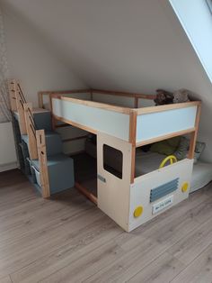 there is a loft bed made out of wood and white paint on the bottom bunk