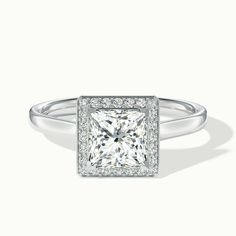 a princess cut diamond ring with pave set diamonds on the shoulders and sides, in white gold