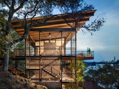 the house is built on top of a hill with stairs leading up to it's roof