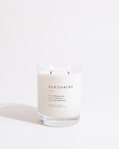 a white candle sitting on top of a table