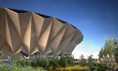 an artist's rendering of the exterior of a stadium with flowers and trees around it