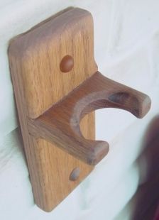 a wooden hook on the side of a wall