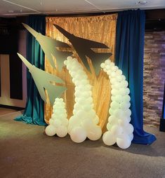 an airplane balloon arch in the middle of a room