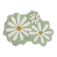 three white daisies on a green rug