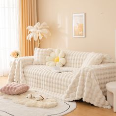 a white couch sitting on top of a hard wood floor