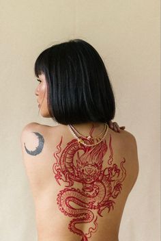 a woman with a dragon tattoo on her back