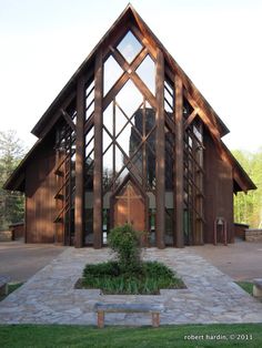 a large wooden building sitting on top of a lush green field