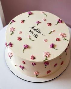 a white cake with pink flowers on it