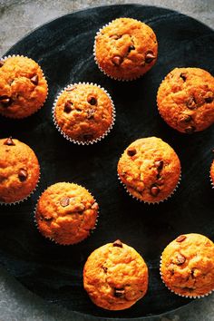 a black plate topped with muffins on top of a table