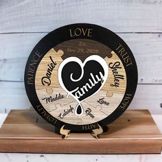 a wooden clock with the words family on it and a heart in the middle that says love