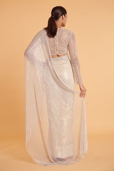 Ivory saree in crystal mesh and tencel georgette base. Comes with a blouse. - Aza Fashions Elegant Floor-length Blouse With Sheer Dupatta, White Party Wear Pre-draped Saree With Sheer Dupatta, Festive Elegant Blouse With Sheer Sleeves, Elegant Long Sleeve Blouse With Sheer Dupatta, Elegant Sheer Blouse For Party, Sheer Blouse Piece For Wedding, Festive Glamorous White Saree, White Bollywood Saree For Evening, Bollywood Style White Evening Saree