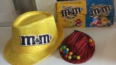 a yellow hat and candy bag sitting on top of a counter next to each other