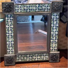 a mirror sitting on top of a wooden table