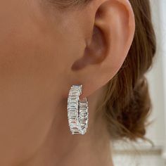 These are definitely not your mamas hoops earrings! Say hello to these exquisite one of a kind 9 ctw natural emerald cut diamond hoop earrings. This item is sold as a pair. If interested in buying as a single, please contact us. Metal: 18k White Gold / 18k Yellow Gold / 18k Rose Gold 30 Emerald Cut Natural Diamonds: Approx. 9.00 ctw per pair Double Sided Hoop G/H Color and VS Clarity Diamonds Diameter: Approx. 25mm Closure: Latch back Double Hoops Earring, Silver Hoop Jewelry With Baguette Diamonds, Silver Hoop Earrings With Baguette Diamonds, Baguette Diamond Hoop Earrings As Gift, Silver Baguette Cut Hoop Earrings, Hoop Earrings With Baguette Diamonds, Baguette Diamond Hoop Earrings For Wedding, Emerald Cut Diamond Earrings, College Rings