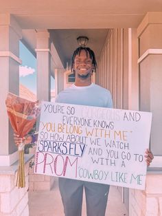 a man holding a sign that says you're so gorgeous and you everyone knows