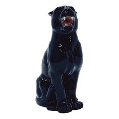 a black dog statue with its mouth open