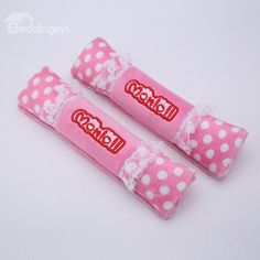 two pink and white polka dot candy rolls with the word candy written on each one