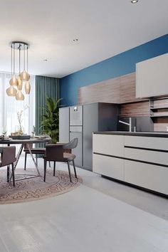 a modern kitchen with blue walls and white cabinets