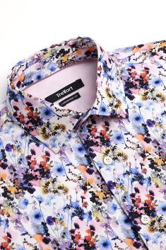 This shirt is perfect for those who want to make a statement with their fashion sense. The unique prints on a white backdrop make it stand out from the typical plain dress shirts, while the blue, light pink to red tones and touch of pale purple color adds a pop of personality and liveliness to the overall look Luxury Menswear