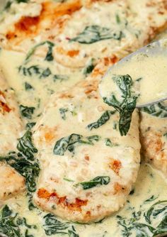 spinach and cheese sauce being stirred in a skillet with a spatula on top