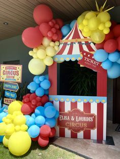 a carnival booth decorated with balloons and streamers