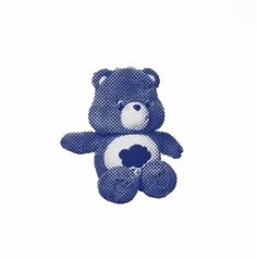 a blue teddy bear sitting on top of a white surface