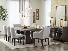 the dining room table is surrounded by gray chairs