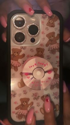 someone holding up their cell phone case to show it's cover with teddy bears on it