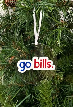 a glass ornament with the word go bills on it hanging from a christmas tree