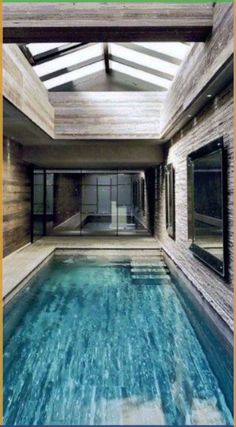 an indoor swimming pool in the middle of a house