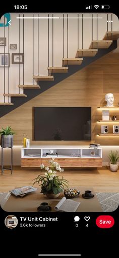 a living room with stairs and a flat screen tv