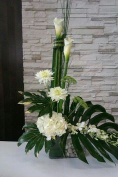 a vase filled with white flowers on top of a table