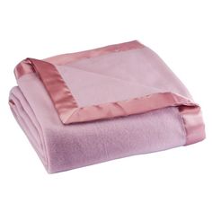 the pink blanket is folded on top of each other