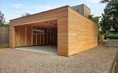 a large wooden building sitting on top of a gravel field