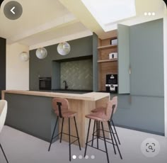 an image of a modern kitchen setting with bar stools and countertop space in the center