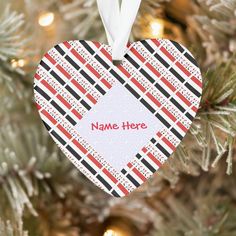 a heart shaped ornament hanging from a christmas tree