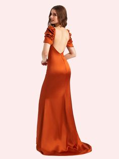 a woman in an orange dress is looking back