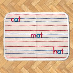 a bath mat with the word cat not on it in red, white and blue stripes