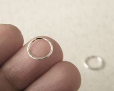 This septum ring is made of sterling silver. You can choose between simple or hammered septum ring. The edges of the ring are treated like stud earrings. Ships with priority mail, upgrade to REGISTERED mail available at checkout. Measurements: width 0.8 mm= 0.031in=20 gouge. The size on the picture is 8 mm in diameter. You can choose 8 mm- 05⁄16in, or 10mm- 025⁄64in or 12mm-015⁄32in. If you need other size, please let me know! Do you want it oxidized or with texture? Send a message and I will ha Minimalist Sterling Silver Small Hoop Septum Ring, Dainty Silver Septum Ring For Everyday, Tiny Silver Minimalist Septum Ring, Handmade Minimalist Sterling Silver Septum Ring, Minimalist Hypoallergenic Nose Ring, Tiny Sterling Silver Nose Rings, Tiny Minimalist Round Nose Rings, Minimalist Septum Ring Gift, Tiny Minimalist Sterling Silver Nose Rings