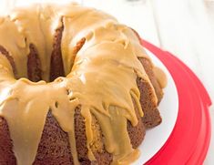 a bundt cake with frosting on a red plate